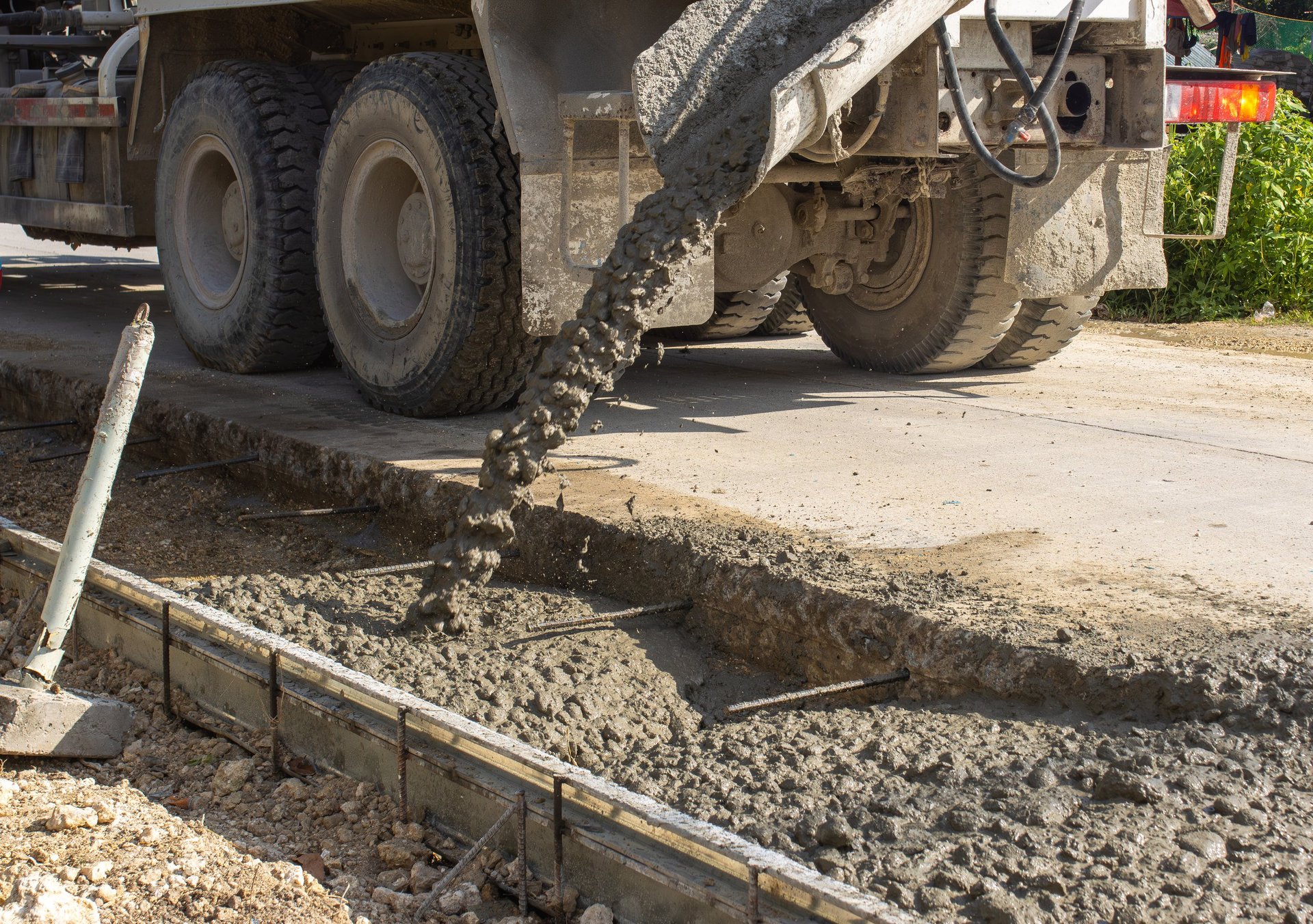 Construction of a concrete highway with a concrete mixer pouring concrete